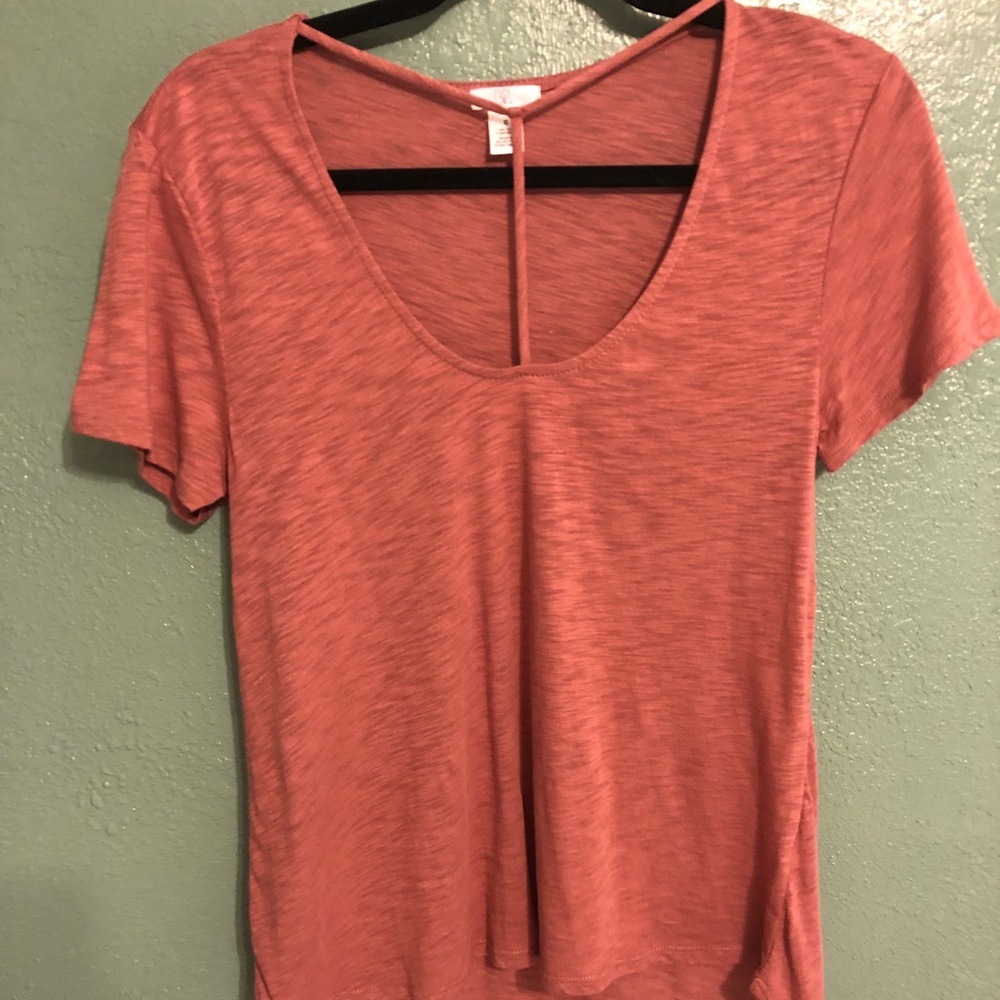 Pink blouse w/ T-strap detail across the chest